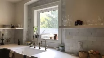 Light rectangular tile backsplash around a kitchen window and sink