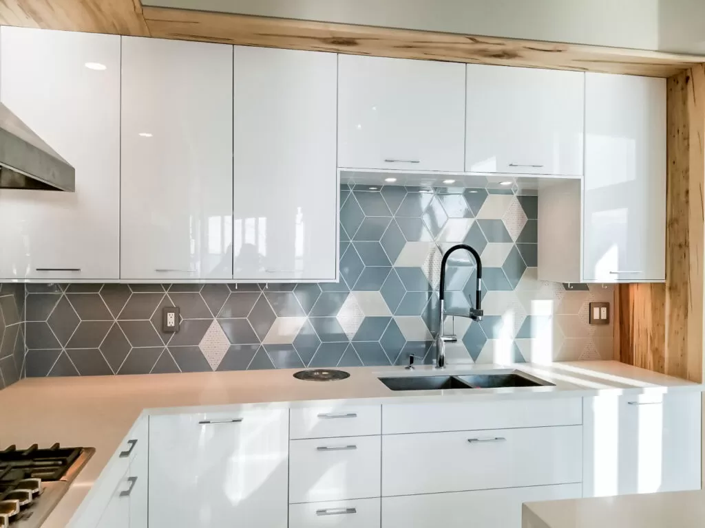 Blue-grey geometric kitchen backsplash with light diamond accents