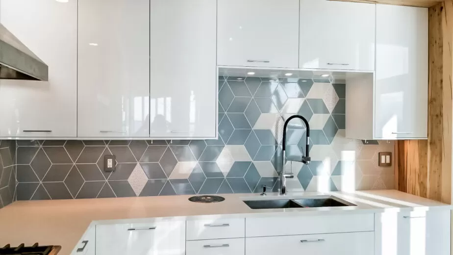 Blue-grey geometric kitchen backsplash with light diamond accents