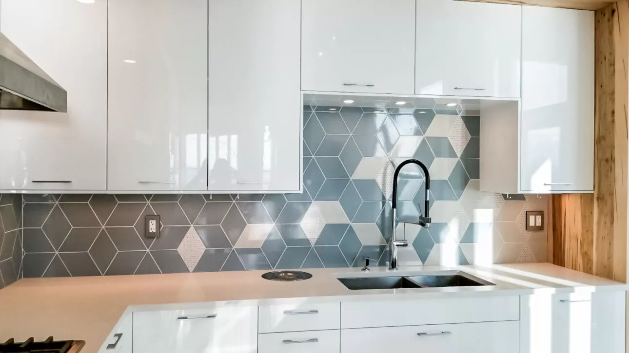 Blue-grey geometric kitchen backsplash with light diamond accents