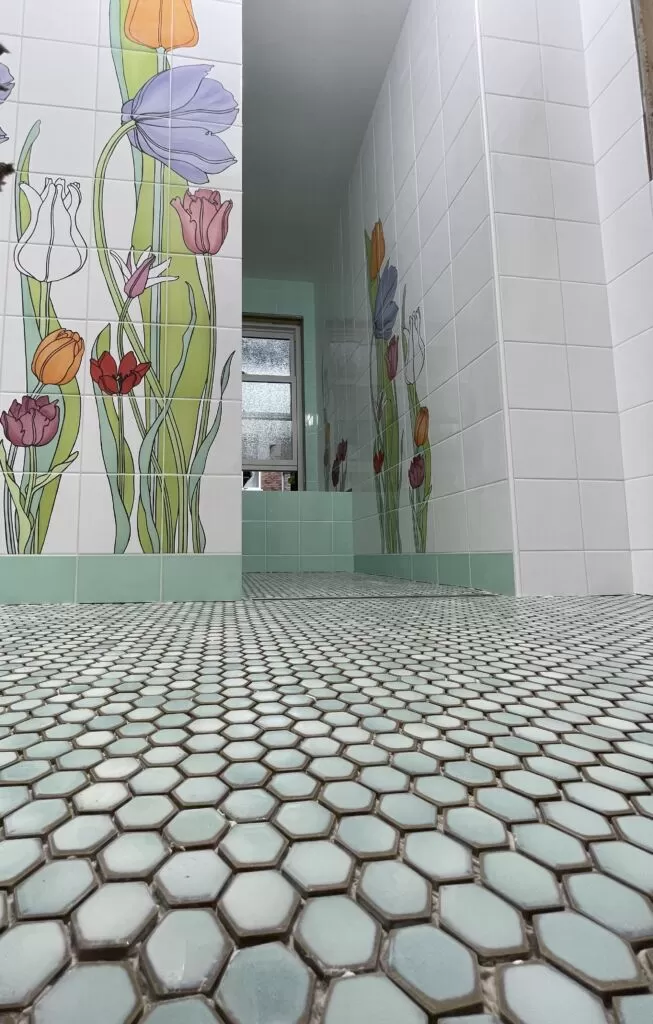 Floral bathroom wall tile, green accents and small hexagon mosaic floor