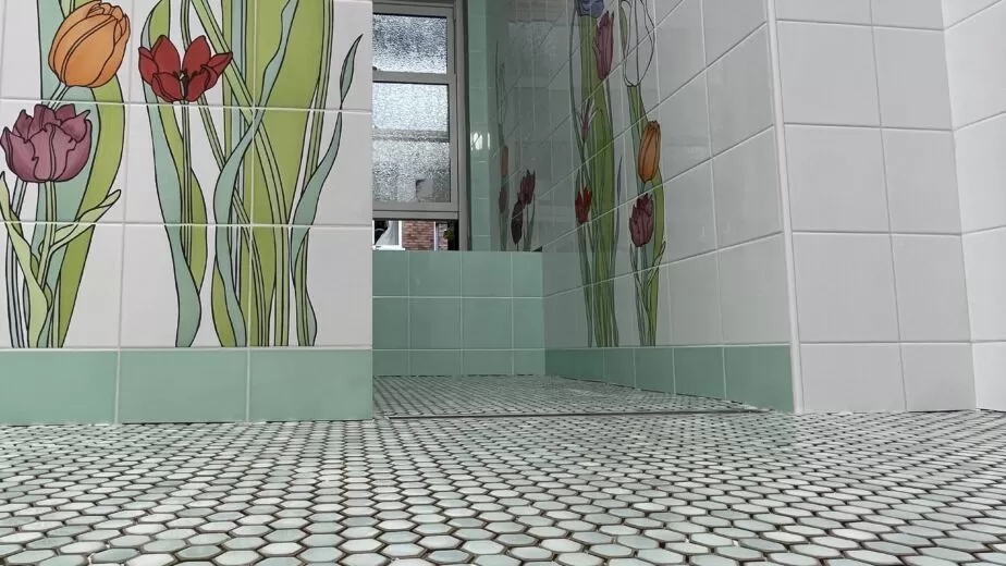 Floral bathroom wall tile, green accents and small hexagon mosaic floor