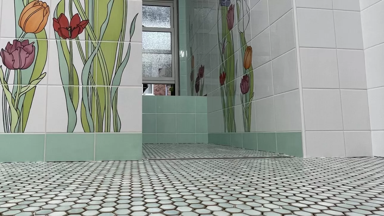 Floral bathroom wall tile, green accents and small hexagon mosaic floor